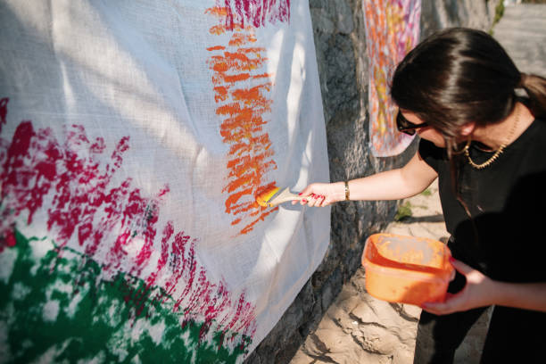 istock Woman painting a cloth 1387443892