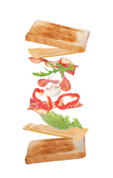 istock Delicious sandwich with flying toasted bread, fried bacon and other ingredients on white background 1387444081