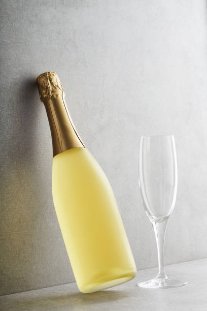 Champagne Bottle and glass Sparkling wine bottle and empty Champagne flute against grey concrete background Bottle of Prosecco stock pictures, royalty-free photos & images