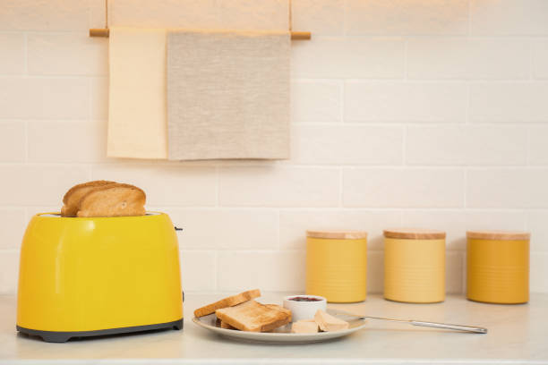 istock Modern toaster and tasty breakfast on counter in kitchen 1387444546