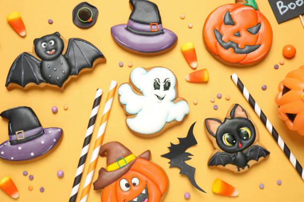 istock Different decorated gingerbread cookies on yellow background, flat lay. Halloween celebration 1387445138