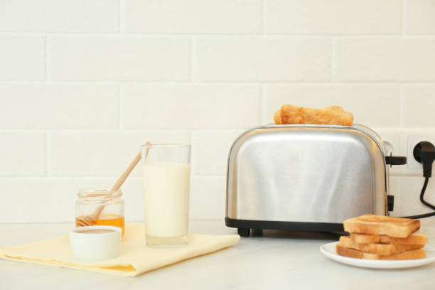 istock Modern toaster and tasty breakfast on counter in kitchen 1387445957