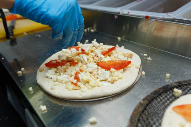 chef preparing pizza on metal table, closeup. - pizza sauces chef making imagens e fotografias de stock