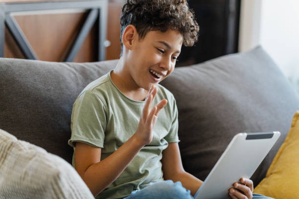 istock Teenage boy using digital tablet at home 1387450225