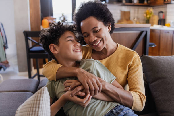 istock Mother and son hugging on the sofa 1387450228