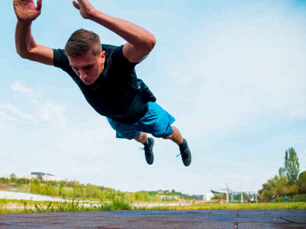 istock Fitness man doing clapping push-ups during outdoor cross training workout. Handsome young and fit fitness sport model training outside in park 1387452046
