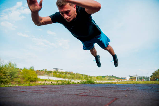 istock Fitness man doing clapping push-ups exercise intense training outdoors 1387452048