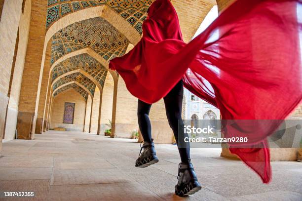 Woman In Red Cloak Running Traditional Iranian Style Courtyard Stock Photo - Download Image Now