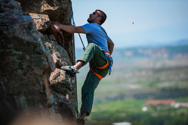 istock Male rock climber on challenging route 1387452378