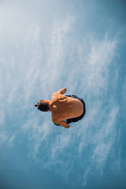 istock Parkour man doing backflip in the air 1387452970