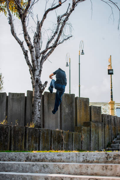 istock Courage man climbing on wall at urban place 1387453044