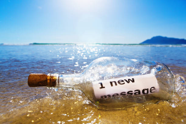 Souvenir Glass bottle with Sea shell. Seashell in glass bottle with seashells on the seashore sandy beach. Ocean seashell. Summer Memories from vacation Concept for travel agency