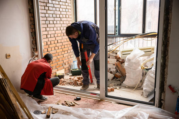 Professional constructors installing wide PVC window