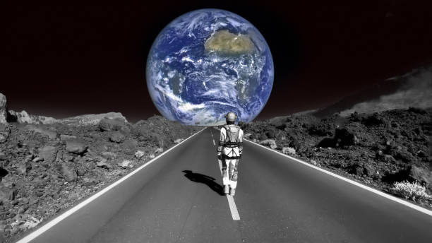 istock Astronaut walking down a road on the moon. Going home to earth 1387453771