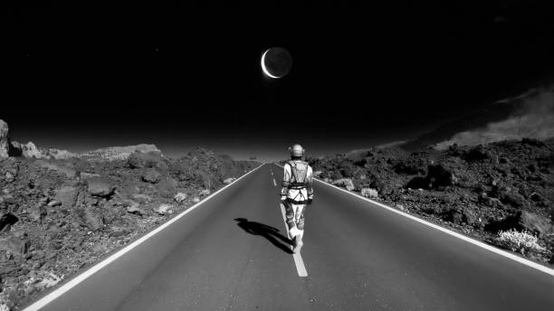 Astronaut walking down a road on mars. Going home to the moon