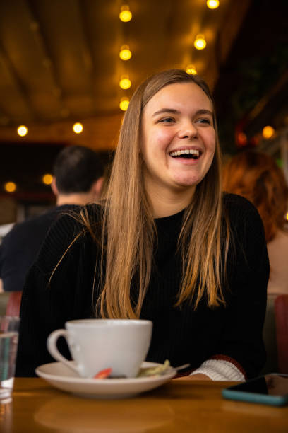 istock Happy young woman in cafe 1387455094