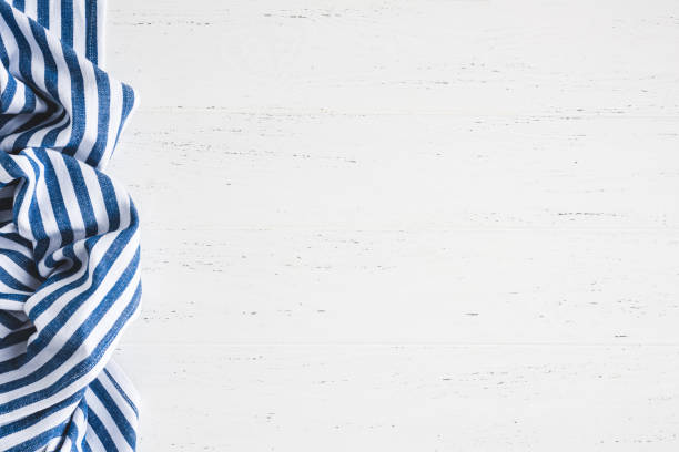 istock White wooden background with blue striped textile 1387459402