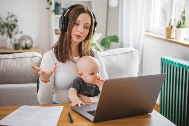 istock Young mother working from home 1387459427