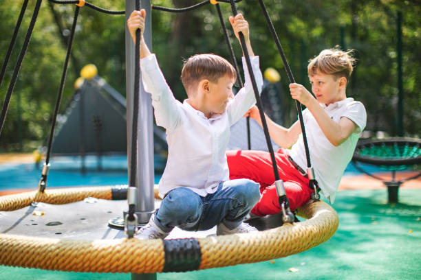 istock Preschool boys enjoying at playground 1387459696