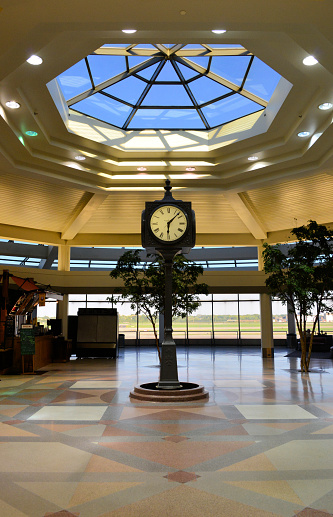 Milwaukee, Wisconsin, USA: General Mitchell International Airport - vintage cast iron clock on a pedestal - MKE central mall - 6:07.