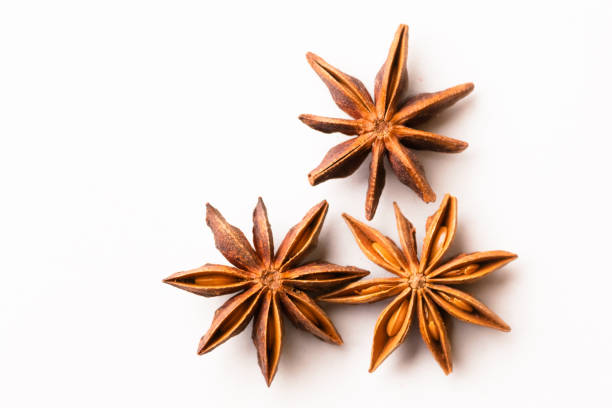 istock Three star anise whole spices pods on white colored background with copy space. 1387461194