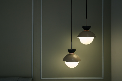 Modern ceiling lamp on background. Copy space