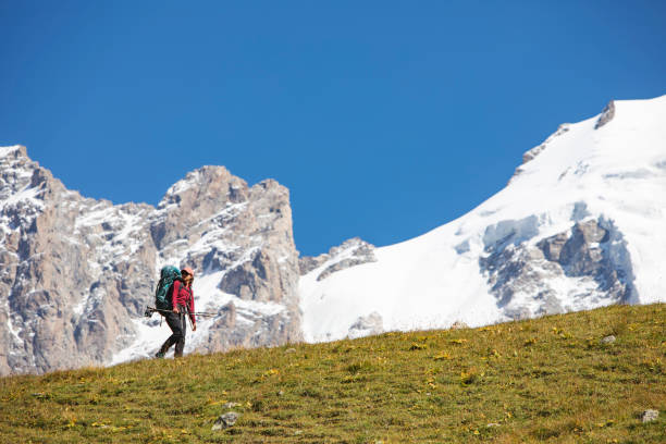 istock Young woman trekking in mountains 1387462662