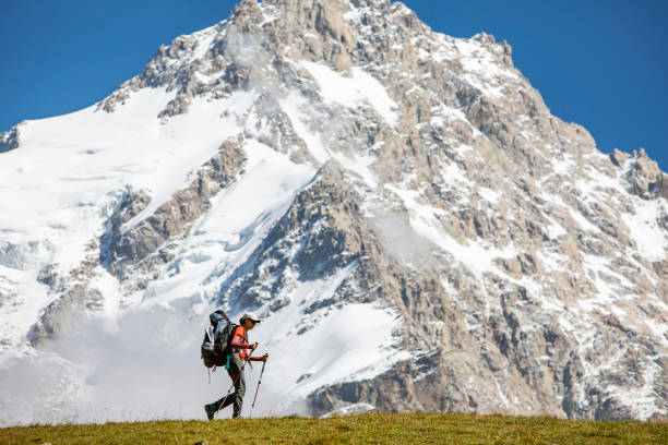 istock Young woman trekking in mountains 1387462691