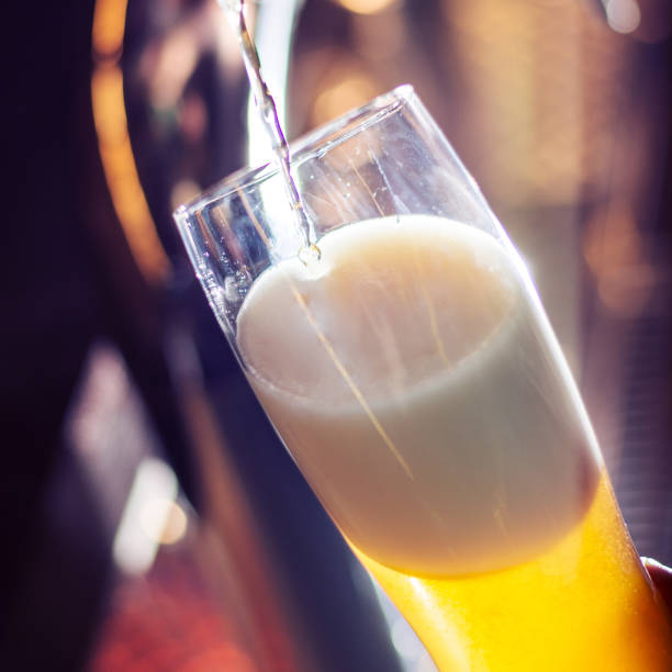 istock bartender pouring craft beer to glass 1387464409