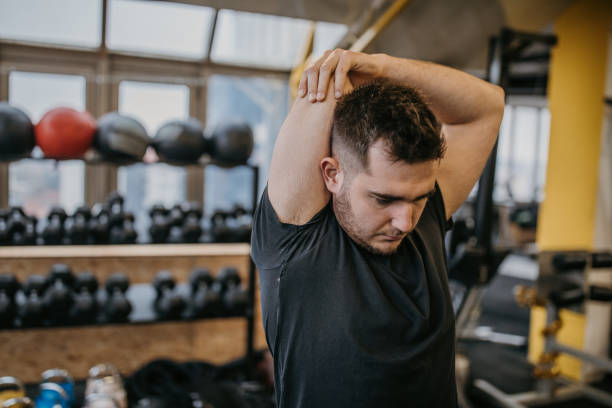 istock Male exercising in gym 1387465580