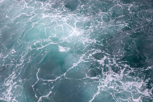istock Water surface. Wake waves and foam on the blue sea water 1387466673