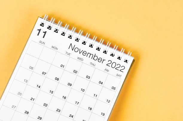 istock November 2022 desk calendar on light yellow background. 1387466820