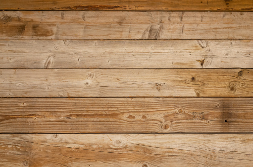 Weathered sawn wood planks used for flooring or boarding up empty premises.