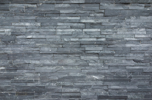 Exterior wall facade constructed from slate stone cladding panels.