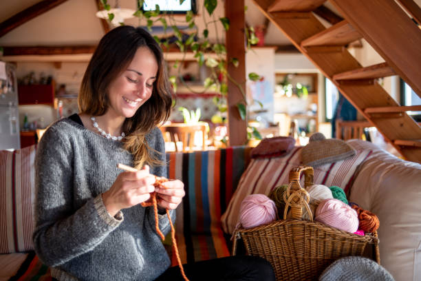 istock Young knitter woman relaxing and working at home 1387468424