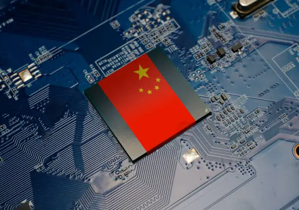Photo of Flag of China on CPU operating chipset computer electronic circuit board, American technology or hardware development related conceptual