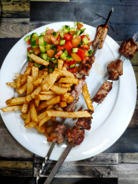 Serving and eating vegetable and chicken skewers