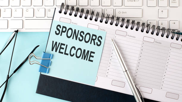 istock SPONSORS WELCOME text on blue sticker on planning and keyboard,blue background 1387472159