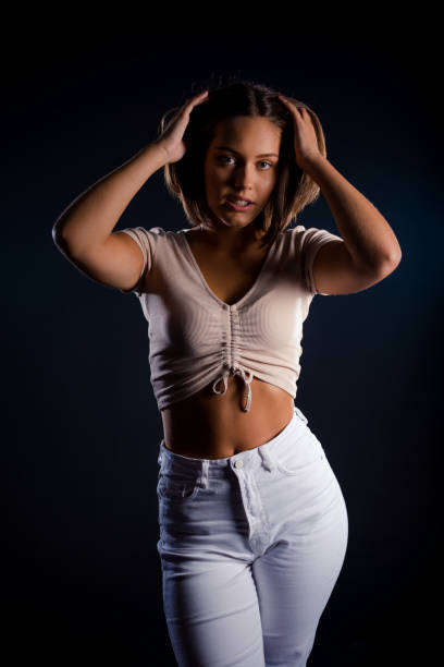 istock Beautiful young woman posing in modern studio 1387474039