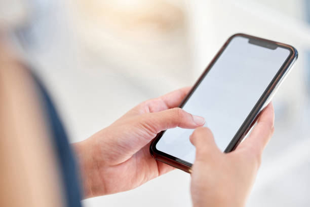 istock Shot of an unrecognizable businessperson using a phone at work 1387474804