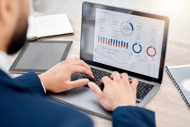 istock Shot of an unrecognizable businessperson using a laptop at work 1387474805