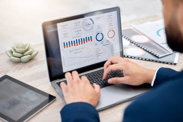 istock Shot of an unrecognizable businessperson using a laptop at work 1387474808