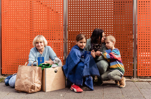 Ukrainian regugees family waiting for registration in charity organization stock photo