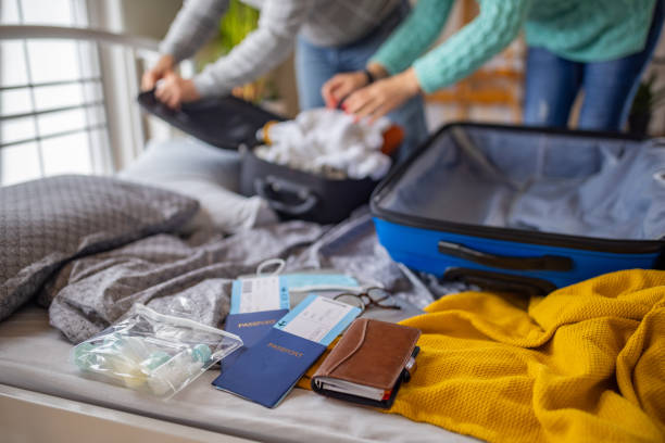 istock Unrecognizable couple packing their stuff into suitcase 1387477820