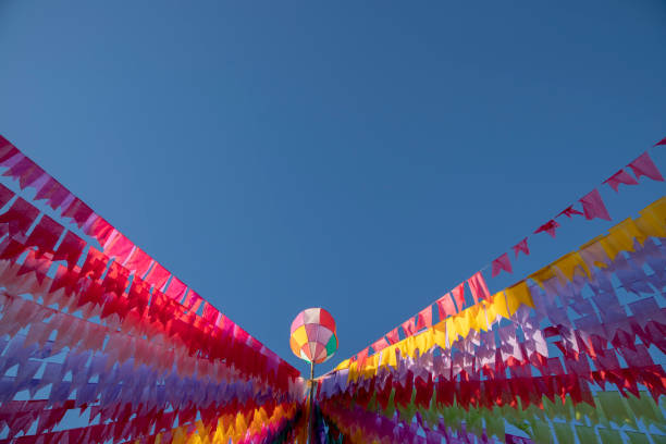 colorful bandeirinhas with junino balloon to the bottom center of the image - balão enfeite imagens e fotografias de stock