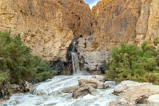 The famous biblical stream Kidron. Ancient Judean mountains on the shores of the Dead Sea. Cold rainy winter in Israel. Winter flood on the Kidron stream.