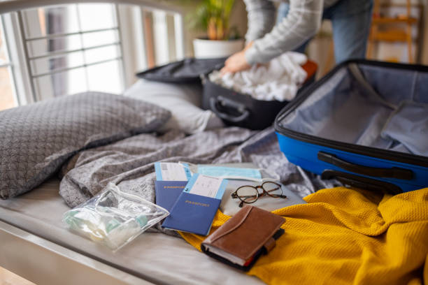 istock Unrecognizable senior couple packing their stuff into suitcase 1387479081