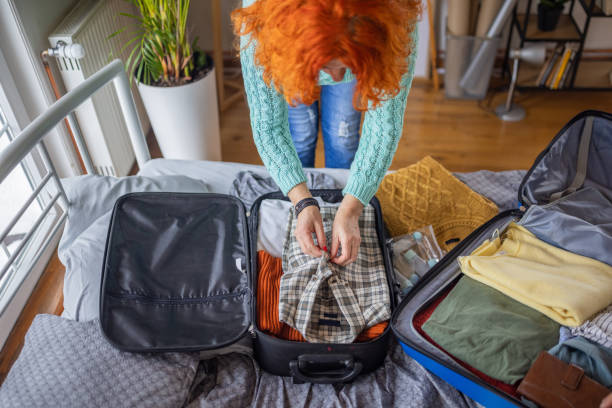 istock Unrecognizable senior woman packing her clothes into suitcase 1387479119