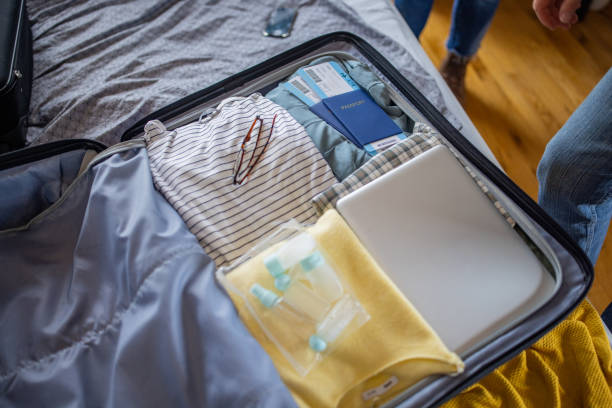 istock Suitcase with packed clothes and personal accessory, passport and airplane ticket 1387479271