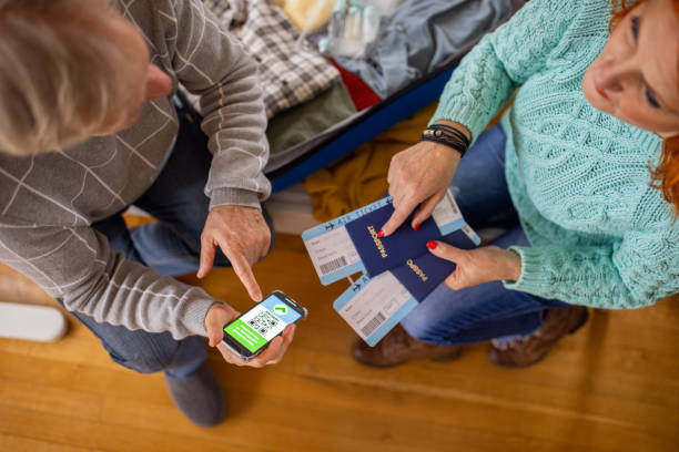istock Husband showing immunization certificate on mobile phone to his wife 1387479430